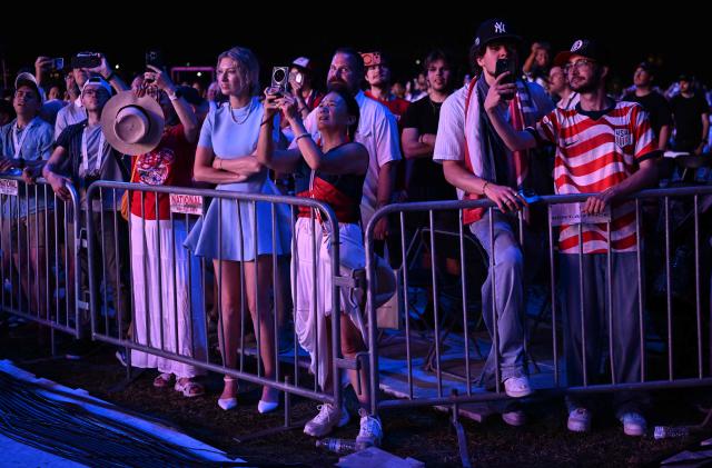 Attendees watch fireworks during the "Salute to America" Independence Day celebration on the National Mall in Washington, DC, in the early morning hours of July 5, 2026. The nation is marking the 250th anniversary of the United States Declaration of Indpendence. (Photo by Alex WROBLEWSKI / AFP)