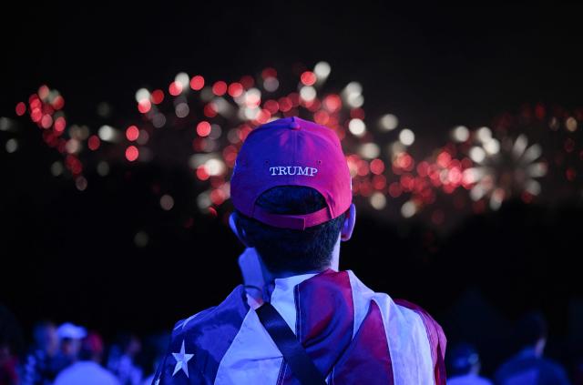 A young Trump supporter is watching fireworks during the "Salute to America" Independence Day celebration on the National Mall in Washington, DC, in the early morning hours of July 5, 2026. The nation is marking the 250th anniversary of the United States Declaration of Indpendence. (Photo by Alex WROBLEWSKI / AFP)