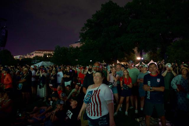 Attendees watch fireworks during the "Salute to America" Independence Day celebration on the National Mall in Washington, DC, in the early morning hours of July 5, 2026. The nation is marking the 250th anniversary of the United States Declaration of Indpendence. (Photo by Alex WROBLEWSKI / AFP)