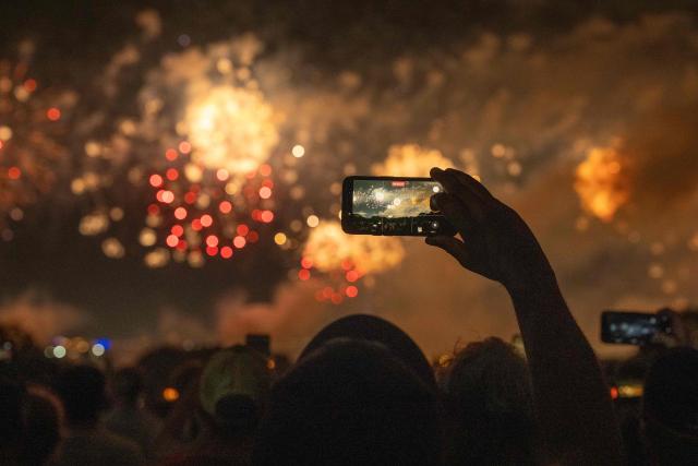 People watch fireworks during the "Salute to America" Independence Day celebration in Washington, DC, in the early morning hours of July 5, 2026. The nation is marking the 250th anniversary of the United States Declaration of Indpendence. (Photo by Ken Cedeno / AFP)