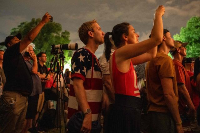People watch fireworks during the "Salute to America" Independence Day celebration in Washington, DC, in the early morning hours of July 5, 2026. The nation is marking the 250th anniversary of the United States Declaration of Indpendence. (Photo by Ken Cedeno / AFP)