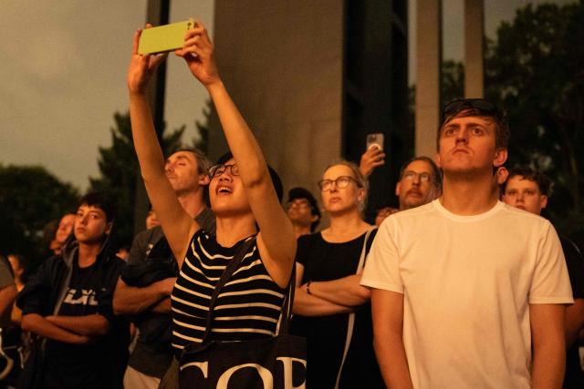 People watch fireworks during the "Salute to America" Independence Day celebration in Washington, DC, in the early morning hours of July 5, 2026. The nation is marking the 250th anniversary of the United States Declaration of Indpendence. (Photo by Ken Cedeno / AFP)