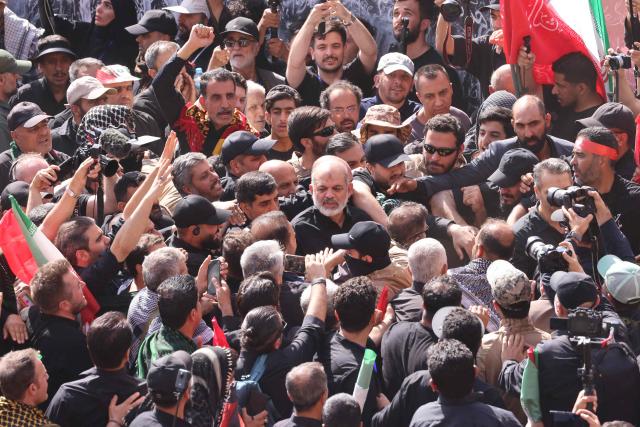 Chief of Iran's Revolutionary Guards, Ahmad Vahidi (C) arrives to gather with mourners at the Grand Mosalla to pay their final respects to Iran's slain supreme leader Ayatollah Ali Khamenei during the second day of funeral ceremonies in Tehran on July 5, 2026. Prayers were held July 5 over the casket of Iran's late supreme leader Ali Khamenei, the second day of funeral ceremonies that have drawn huge crowds to pay their final respects in Tehran. Khamenei ruled the Islamic republic from 1989 until he was killed aged 86 in an airstrike on the first day of the US-Israeli war with Iran on February 28. (Photo by ATTA KENARE / AFP) / 