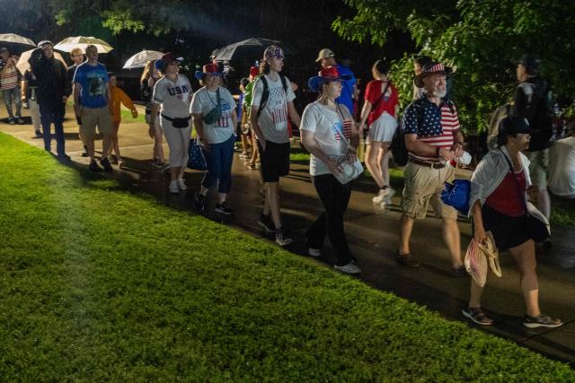 People walk to the the Netherlands Carillon to watch the fireworks during the "Salute to America" Independence Day celebration on the National Mall in Washington, DC, on July 4, 2026. The nation is marking the 250th anniversary of the United States Declaration of Indpendence. (Photo by Ken Cedeno / AFP)