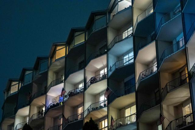 People sit on their balconies to watch the fireworks during the "Salute to America" Independence Day celebration on the National Mall in Washington, DC, on July 4, 2026. The nation is marking the 250th anniversary of the United States Declaration of Indpendence. (Photo by Ken Cedeno / AFP)