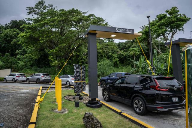 Cars line up at a McDonald's drive-thru ahead as the forecasted Super Typhoon Bavi approaches in Guam, Northern Mariana Islands, on July 5, 2026. People in Guam and the Northern Marianas moved to emergency evacuation centers and made last-minute preparations on July 5, hours before a "super typhoon" was projected to bulldoze through the US Pacific territories. (Photo by Yuichi YAMAZAKI / AFP)