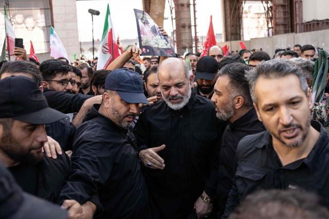 Chief of Iran's Revolutionary Guards, Ahmad Vahidi (C) arrives to pray for Iran's slain supreme leader Ayatollah Ali Khamenei with mourners during the second day of funeral ceremonies at the Grand Mosalla in Tehran on July 5, 2026. Prayers were held July 5 over the casket of Iran's late supreme leader Ali Khamenei, the second day of funeral ceremonies that have drawn huge crowds to pay their final respects in Tehran. Khamenei ruled the Islamic republic from 1989 until he was killed aged 86 in an airstrike on the first day of the US-Israeli war with Iran on February 28. (Photo by AFP) / 