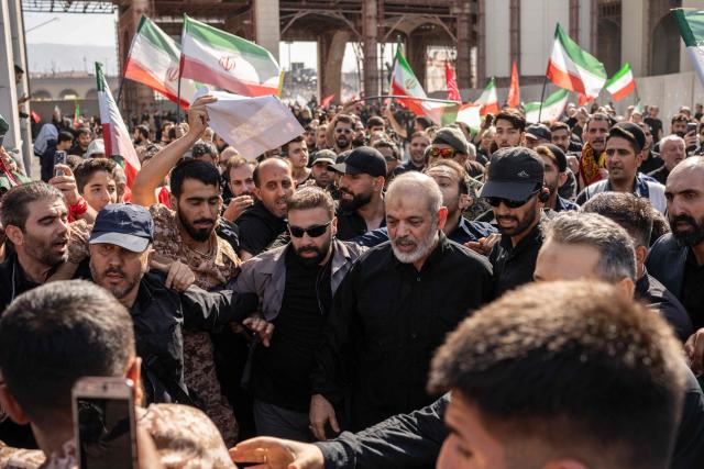 Chief of Iran's Revolutionary Guards, Ahmad Vahidi (C) arrives to pray for Iran's slain supreme leader Ayatollah Ali Khamenei with mourners during the second day of funeral ceremonies at the Grand Mosalla in Tehran on July 5, 2026. Prayers were held July 5 over the casket of Iran's late supreme leader Ali Khamenei, the second day of funeral ceremonies that have drawn huge crowds to pay their final respects in Tehran. Khamenei ruled the Islamic republic from 1989 until he was killed aged 86 in an airstrike on the first day of the US-Israeli war with Iran on February 28. (Photo by AFP) / 