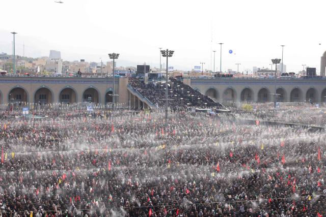 Mourners gather under the water-mist fans installed at the Grand Mosalla to pray for Iran's slain supreme leader Ayatollah Ali Khamenei during the second day of funeral ceremonies in Tehran on July 5, 2026. Prayers were held July 5 over the casket of Iran's late supreme leader Ali Khamenei, the second day of funeral ceremonies that have drawn huge crowds to pay their final respects in Tehran. Khamenei ruled the Islamic republic from 1989 until he was killed aged 86 in an airstrike on the first day of the US-Israeli war with Iran on February 28. (Photo by ATTA KENARE / AFP) / 