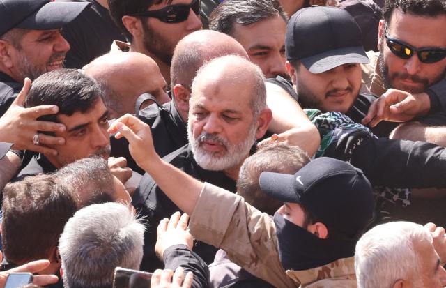 Chief of Iran's Revolutionary Guards, Ahmad Vahidi (C) arrives to pray for Iran's slain supreme leader Ayatollah Ali Khamenei with mourners during the second day of funeral ceremonies at the Grand Mosalla in Tehran on July 5, 2026. Prayers were held July 5 over the casket of Iran's late supreme leader Ali Khamenei, the second day of funeral ceremonies that have drawn huge crowds to pay their final respects in Tehran. Khamenei ruled the Islamic republic from 1989 until he was killed aged 86 in an airstrike on the first day of the US-Israeli war with Iran on February 28. (Photo by ATTA KENARE / AFP) / 