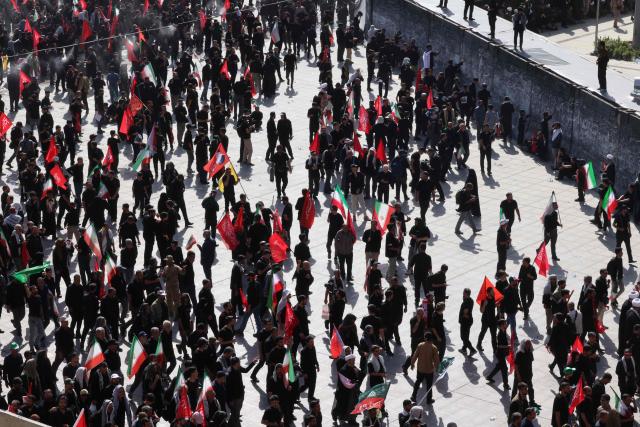 Mourners leave after gathering under the water-mist fans installed at the Grand Mosalla to pray for Iran's slain supreme leader Ayatollah Ali Khamenei during the second day of funeral ceremonies in Tehran on July 5, 2026. Prayers were held July 5 over the casket of Iran's late supreme leader Ali Khamenei, the second day of funeral ceremonies that have drawn huge crowds to pay their final respects in Tehran. Khamenei ruled the Islamic republic from 1989 until he was killed aged 86 in an airstrike on the first day of the US-Israeli war with Iran on February 28. (Photo by ATTA KENARE / AFP) / 