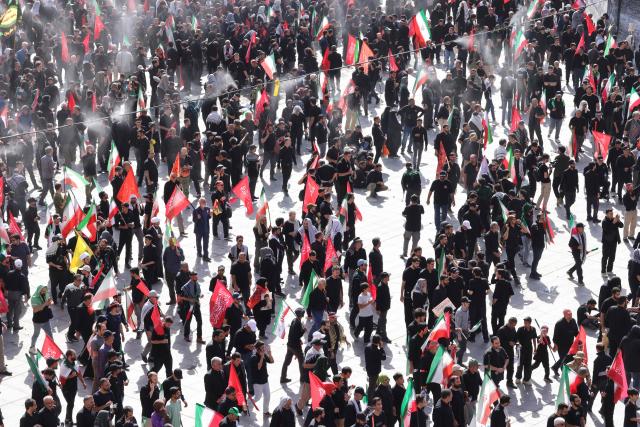 Mourners gather under the water-mist fans installed at the Grand Mosalla to pray for Iran's slain supreme leader Ayatollah Ali Khamenei during the second day of funeral ceremonies in Tehran on July 5, 2026. Prayers were held July 5 over the casket of Iran's late supreme leader Ali Khamenei, the second day of funeral ceremonies that have drawn huge crowds to pay their final respects in Tehran. Khamenei ruled the Islamic republic from 1989 until he was killed aged 86 in an airstrike on the first day of the US-Israeli war with Iran on February 28. (Photo by ATTA KENARE / AFP) / 