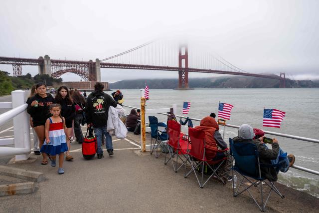 Fog obscures the tops of the Golden Gate Bridge as people stake out their places to watch a fireworks show celebrating the 250th anniversary of US Independence Day in San Francisco, California on July 4, 2026. (Photo by Karl Mondon / AFP)