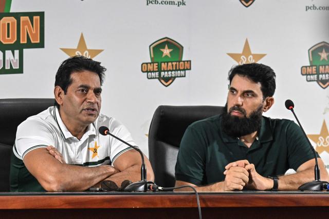 Pakistan national cricket selection committee members Aaqib Javed (L) and Misbah-ul-Haq address a press conference in Lahore on July 5, 2026. Pakistan on July 5 replaced struggling Test captain Shan Masood with Babar Azam, who will start a third stint as skipper on the tours of the West Indies and England starting later this month. (Photo by Arif ALI / AFP)