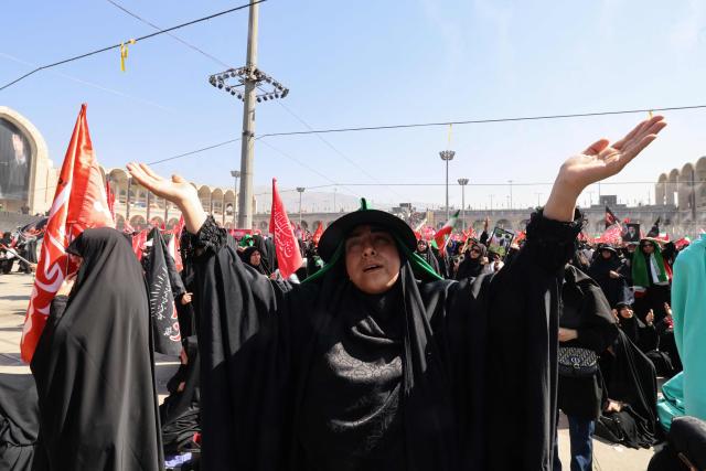A mourner reacts as she pays respect at the Grand Mosalla where people gathered to pray for Iran's slain supreme leader Ayatollah Ali Khamenei during the second day of funeral ceremonies in Tehran on July 5, 2026. Prayers were held July 5 over the casket of Iran's late supreme leader Ali Khamenei, the second day of funeral ceremonies that have drawn huge crowds to pay their final respects in Tehran. Khamenei ruled the Islamic republic from 1989 until he was killed aged 86 in an airstrike on the first day of the US-Israeli war with Iran on February 28. (Photo by ATTA KENARE / AFP) / 