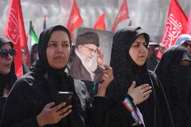 Mourners react as they pay their respects at the Grand Mosalla where they gathered to pray for Iran's slain supreme leader Ayatollah Ali Khamenei during the second day of funeral ceremonies in Tehran on July 5, 2026. Prayers were held July 5 over the casket of Iran's late supreme leader Ali Khamenei, the second day of funeral ceremonies that have drawn huge crowds to pay their final respects in Tehran. Khamenei ruled the Islamic republic from 1989 until he was killed aged 86 in an airstrike on the first day of the US-Israeli war with Iran on February 28. (Photo by ATTA KENARE / AFP) / 