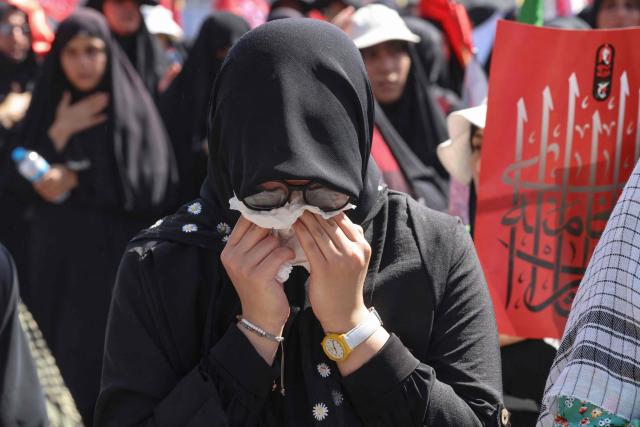 A mourner grieves as people gather to pray for Iran's slain supreme leader Ayatollah Ali Khamenei during the second day of funeral ceremonies at the Grand Mosalla in Tehran on July 5, 2026. Prayers were held July 5 over the casket of Iran's late supreme leader Ali Khamenei, the second day of funeral ceremonies that have drawn huge crowds to pay their final respects in Tehran. Khamenei ruled the Islamic republic from 1989 until he was killed aged 86 in an airstrike on the first day of the US-Israeli war with Iran on February 28. (Photo by ATTA KENARE / AFP) / 