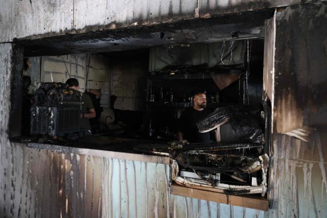 A Palestinian man inspects the aftermath at his restaurant after it was burned down by settlers during an attack in the western area of the Al-Lubban ash-Sharqiya village, south of Nablus, in the occupied West Bank on on July 5, 2026. Violence has escalated in the West Bank, which Israel has occupied since 1967, since the start of the Gaza war in October 2023. (Photo by JAAFAR ASHTIYEH / AFP)