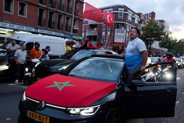 Morocco supporters wave Moroccan national flags as they celebrate, in the streets of Schilderswijk district in The Hague, their team victory in the 2026 World Cup round of 16 football match between Canada and Morocco, on July 4, 2026.  (Photo by Lina Selg / AFP)