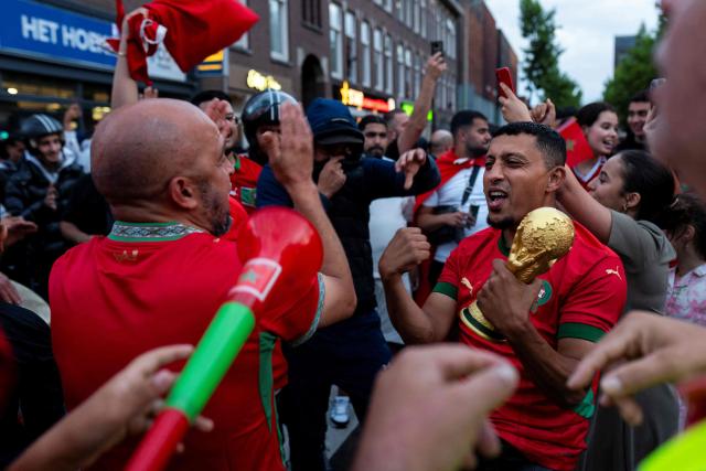 Morocco supporters celebrate, in the streets of Schilderswijk district in The Hague, their team victory in the 2026 World Cup round of 16 football match between Canada and Morocco, on July 4, 2026.  (Photo by Lina Selg / AFP)