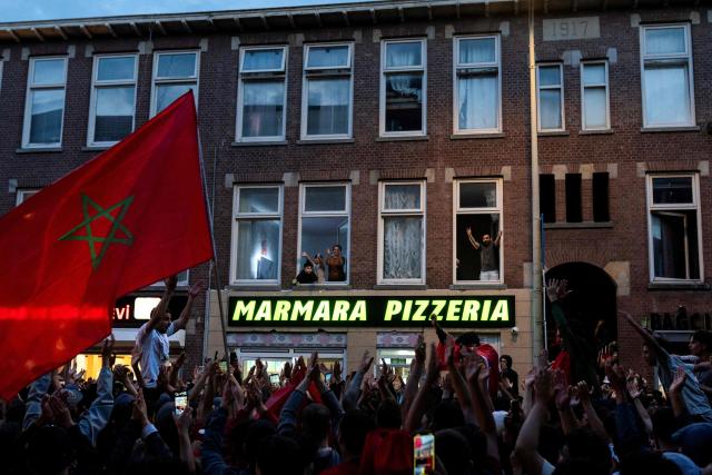 Morocco supporters wave Moroccan national flags as they celebrate, in the streets of Schilderswijk district in The Hague, their team victory in the 2026 World Cup round of 16 football match between Canada and Morocco, on July 4, 2026.  (Photo by Lina Selg / AFP)