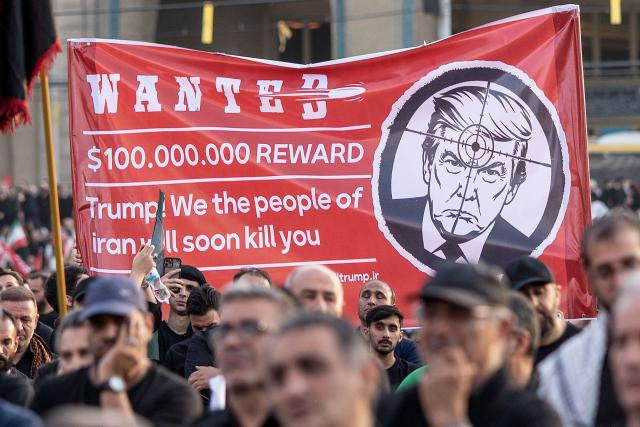 People hold up a revenge banner against US President Donald Trump as they gather to mourn Iran's slain supreme leader Ayatollah Ali Khamenei during the funeral ceremonies at the Grand Mosalla in Tehran on July 5, 2026. Iranian leaders on July 5 joined prayers over the casket of late supreme leader Ali Khamenei during a second day of funeral ceremonies, which was declared a public holiday across Iran. Khamenei's body will be moved out of the Grand Mosalla later in the day, where it is lying in state, as part of preparations for processions through the capital the following day. (Photo by AFP) / 