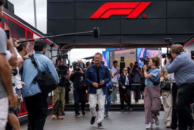 Former Red Bull Racing team principal Christian Horner (C) arrives in the paddock ahead of the Formula One British Grand Prix at the Silverstone motor racing circuit in Silverstone, central England, on July 5, 2026. (Photo by Ben STANSALL / AFP)