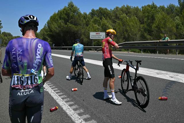 Team Jayco AlUla's Australian rider Kelland O'Brien (L), XDS Astana Team's  New Zealander rider Aaron Gate (C) and Uno-X Mobility team's Danish rider Anthon Charmig (R) recover after suffering a crash shortly after the start of the 2nd stage of the 113th edition of the Tour de France cycling race, 168,5 km between Tarragona and Barcelona in northeastern Spain, on July 5, 2026. (Photo by Loic VENANCE / AFP)
