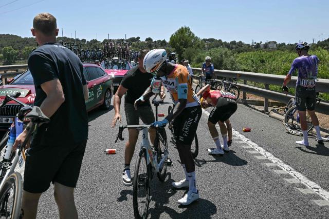 NSN Cycling Team's Eritrean rider Biniam Girmay mounts his bicycle after suffering a crash near the start of the 2nd stage of the 113th edition of the Tour de France cycling race, 168,5 km between Tarragona and Barcelona in northeastern Spain, on July 5, 2026. (Photo by Loic VENANCE / AFP)