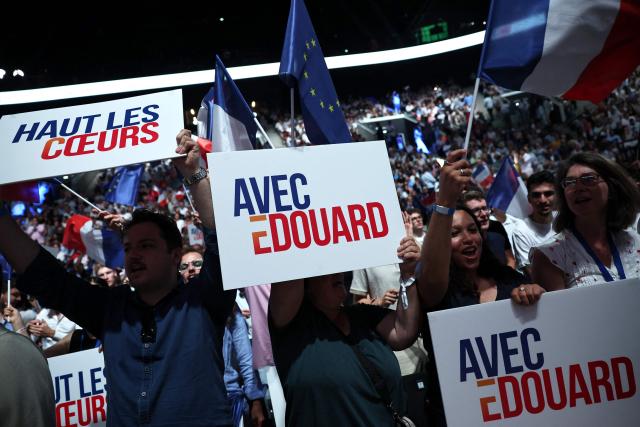 Supporters wave EU and French flags and hold campaign placards during a presidential election campaign rally of French right-wing party Horizons founder and president, mayor of Le Havre and candidate for the 2027 French presidential election Edouard Philippe at the Adidas Arena, in northern Paris on July 5, 2026. (Photo by SIMON WOHLFAHRT / AFP)