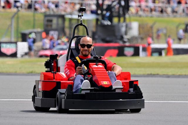 Ferrari's British driver Lewis Hamilton drives a Lego F1 minicart during the drivers parade ahead of the Formula One British Grand Prix at the Silverstone motor racing circuit in Silverstone, central England, on July 5, 2026. (Photo by Andrej ISAKOVIC / AFP)