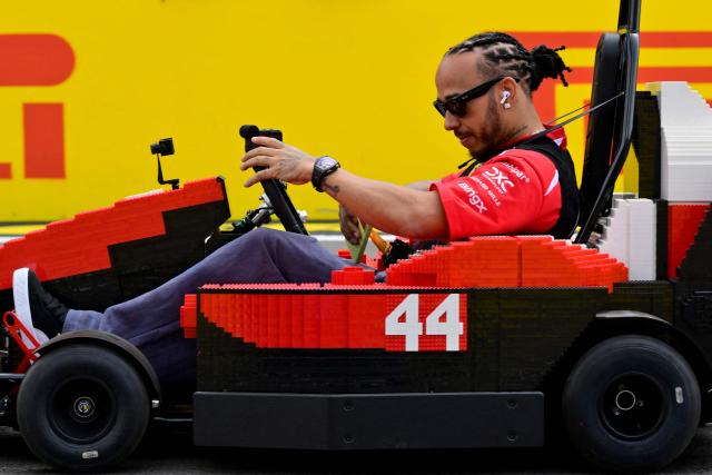 Ferrari's British driver Lewis Hamilton drives a Lego F1 minicart during the drivers parade ahead of the Formula One British Grand Prix at the Silverstone motor racing circuit in Silverstone, central England, on July 5, 2026. (Photo by Andrej ISAKOVIC / AFP)