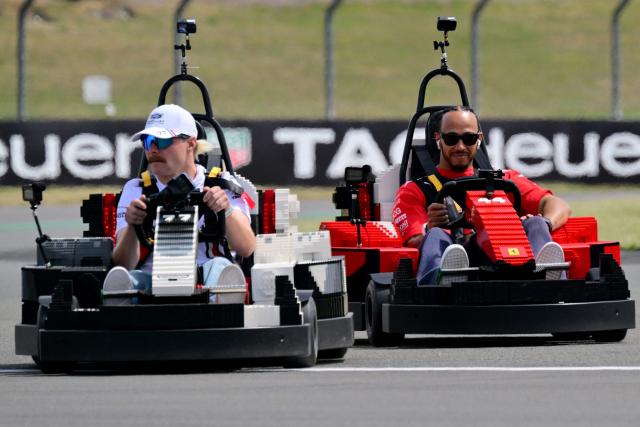 Cadillac's Finnish driver Valtteri Bottas (L) leads Ferrari's British driver Lewis Hamilton (R) as they drive Lego F1 minicarts during the drivers parade ahead of the Formula One British Grand Prix at the Silverstone motor racing circuit in Silverstone, central England, on July 5, 2026. (Photo by Andrej ISAKOVIC / AFP)