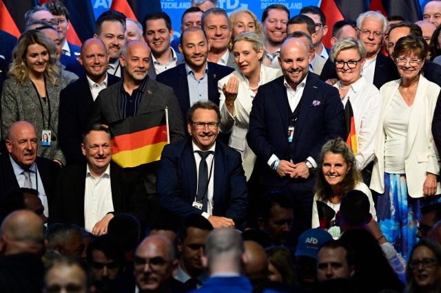 AfD co-leaders Alice Weidel (front C-R) and delegates pose on stage for pictures at the end of the party congress of far-right Alternative for Germany (AfD) at the Messe Erfurt fairground in Erfurt, eastern Germany on July 5, 2026.  (Photo by John MACDOUGALL / AFP)