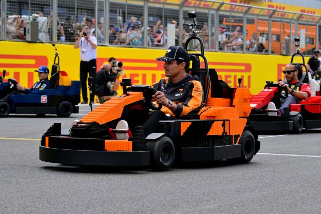 McLaren's British driver Lando Norris (C) drives a Lego minicar during the drivers parade ahead of the Formula One British Grand Prix at the Silverstone motor racing circuit in Silverstone, central England, on July 5, 2026. (Photo by Andrej ISAKOVIC / AFP)