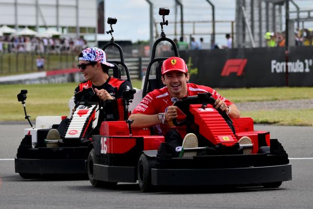 Ferrari's Monegasque driver Charles Leclerc (R) and Haas F1 Team's British driver Oliver Bearman drive Lego minicars during the drivers parade ahead of the Formula One British Grand Prix at the Silverstone motor racing circuit in Silverstone, central England, on July 5, 2026. (Photo by Andrej ISAKOVIC / AFP)
