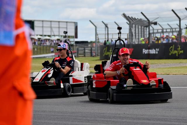 Ferrari's Monegasque driver Charles Leclerc (R) and Haas F1 Team's British driver Oliver Bearman drive Lego minicars during the drivers parade ahead of the Formula One British Grand Prix at the Silverstone motor racing circuit in Silverstone, central England, on July 5, 2026. (Photo by Andrej ISAKOVIC / AFP)