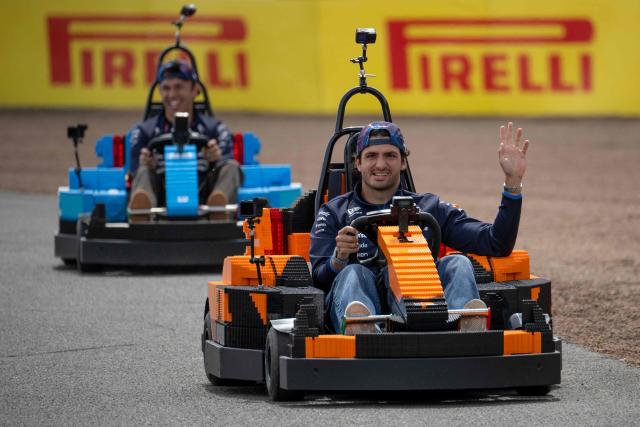 Williams' Spanish driver Carlos Sainz (R) and Williams' Thai driver Alexander Albon (L) drive Lego F1 minicarts during the drivers parade ahead of the Formula One British Grand Prix at the Silverstone motor racing circuit in Silverstone, central England, on July 5, 2026. (Photo by Ben STANSALL / AFP)