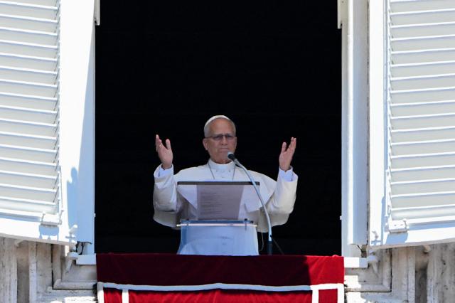 Pope Leo XIV gestures as he leads an Angelus prayer from the window of the apostolic palace overlooking St. Peter's square in The Vatican on July 5, 2026. (Photo by Andreas SOLARO / AFP)