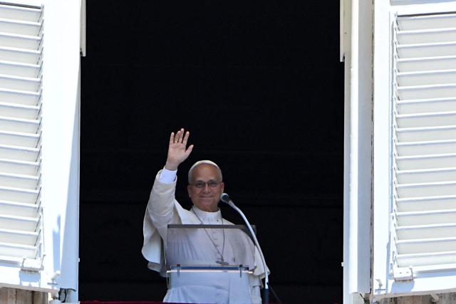 Pope Leo XIV waves to the crowd as he leads an Angelus prayer from the window of the apostolic palace overlooking St. Peter's square in The Vatican on July 5, 2026. (Photo by Andreas SOLARO / AFP)