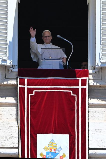 Pope Leo XIV waves to the crowd as he leads an Angelus prayer from the window of the apostolic palace overlooking St. Peter's square in The Vatican on July 5, 2026. (Photo by Andreas SOLARO / AFP)
