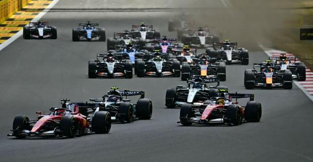 Ferrari's Monegasque driver Charles Leclerc (L) leads Ferrari's British driver Lewis Hamilton (R) and Mercedes' Italian driver Kimi Antonelli (2L) into the first corner during the Formula One British Grand Prix at the Silverstone motor racing circuit in Silverstone, central England, on July 5, 2026. (Photo by Ben STANSALL / AFP) / ALTERNATIVE CROP