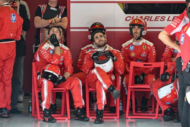 Mechanics for Ferrari's Monegasque driver Charles Leclerc wait in the garage during the Formula One British Grand Prix at the Silverstone motor racing circuit in Silverstone, central England, on July 5, 2026. (Photo by PETER POWELL / POOL / AFP)
