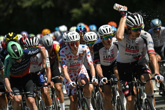 UAE Team Emirates - XRG's Slovenian rider Tadej Pogacar wearing the climber's dotted jersey (C) cycles with the pack of riders (peloton) during the 2nd stage of the 113th edition of the Tour de France cycling race, 168,5 km between Tarragona and Barcelona in northeastern Spain, on July 5, 2026. (Photo by Loic VENANCE / AFP)