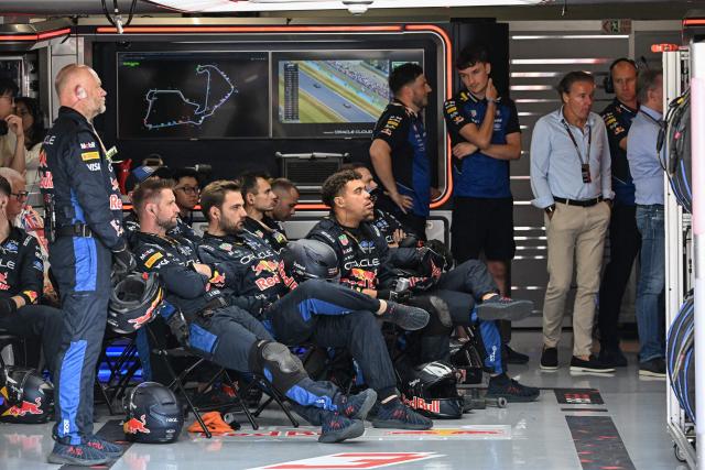 The team for Red Bull Racing's Dutch driver Max Verstappen watch the race from the garage during the Formula One British Grand Prix at the Silverstone motor racing circuit in Silverstone, central England, on July 5, 2026. (Photo by PETER POWELL / POOL / AFP)