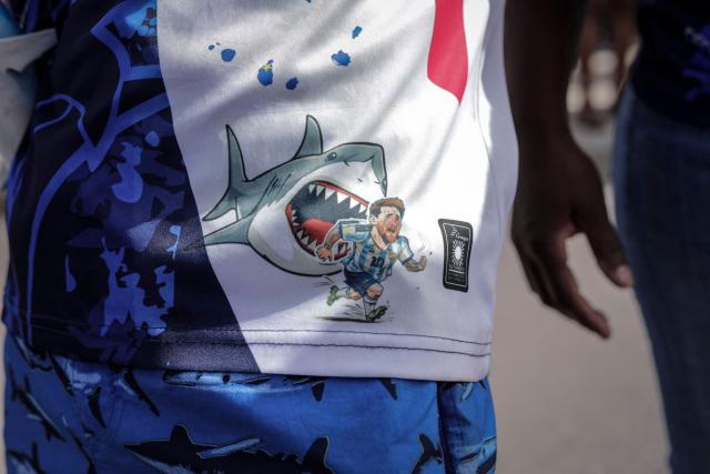 TOPSHOT - A Cape Verde supporter wears shorts depicting Argentina's Lionel Messi being chased by a shark during celebrations in Praia on July 5, 2026, as the national football team returns home following its participation in the 2026 FIFA World Cup. (Photo by Jose Correia / AFP)