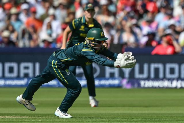 Australia's wicketkeeper Beth Mooney dives to secure a catch off the batting of England's Danni Wyatt-Hodge (not pictured) to dismiss her, during the ICC Women's T20 cricket world cup 2026 final between Australia and England, at Lord's in London on July 5, 2026. (Photo by JUSTIN TALLIS / AFP)