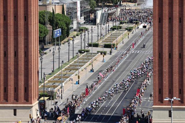 The pack of riders (peloton) cycles past the Venetian Towers during the 2nd stage of the 113th edition of the Tour de France cycling race, 168,5 km between Tarragona and Barcelona in northeastern Spain, on July 5, 2026. (Photo by Josep LAGO / AFP)