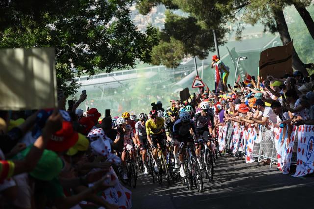 UAE Team Emirates - XRG's Slovenian rider Tadej Pogacar wearing the climber's dotted jersey and Team Visma | Lease a Bike's Danish rider Jonas Vingegaard wearing the overall leader's yellow jersey and riders emerge from yellow smoke as they cycle in the Montjuic Palace ascent in the final kilometers of the 2nd stage of the 113th edition of the Tour de France cycling race, 168,5 km between Tarragona and Barcelona in northeastern Spain, on July 5, 2026. (Photo by Anne-Christine POUJOULAT / AFP)