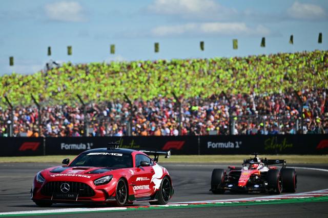 Ferrari's Monegasque driver Charles Leclerc (R) is tucked in behind the safety car (L) during the Formula One British Grand Prix at the Silverstone motor racing circuit in Silverstone, central England, on July 5, 2026. (Photo by Ben STANSALL / AFP)
